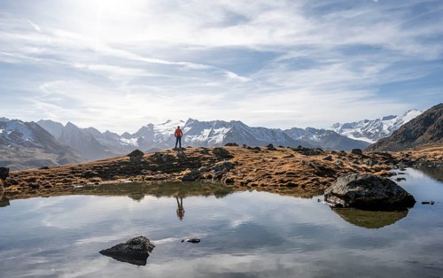 Mountaineers at a small lake on the high plateau of the Gurgler Seenplatte, glaciated mountain