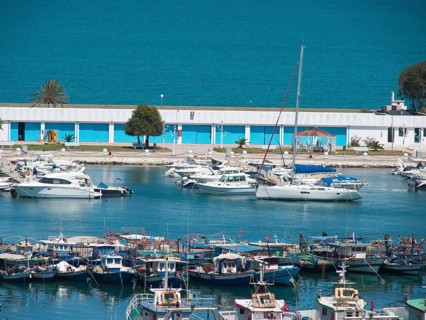 Harbour full of boats and yachts, calm blue water, summery coastal atmosphere, Tunis in Africa with