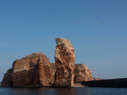 Dramatic cliff formations rise out of the sea into the sky, Heligoland, Germany, Europe