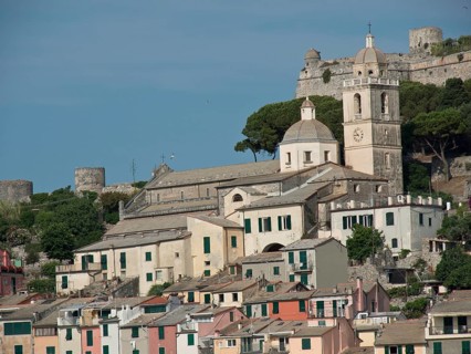 Hilly landscape with a church and bell tower surrounded by houses and castle ruins, Bari, Italy,