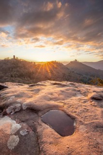 View of Trifels Castle, from Engels Landing rock, with the young tower in autumn at sunset.