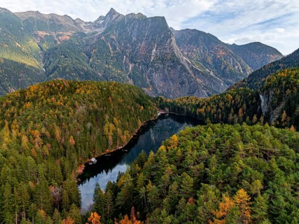 Aerial view, mountain peaks of the Oetztal Alps reflected in Lake Piburger See, in autumn, near