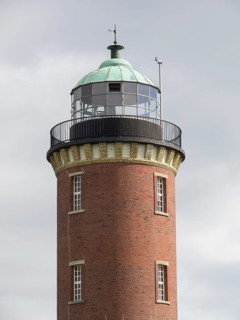 Brick lighthouse with green dome under a partly cloudy sky, Cuxhaven, Germany, Europe
