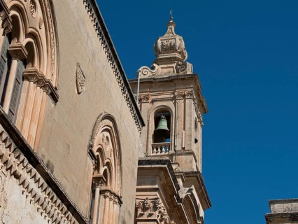 Baroque elements of a historic church tower with bell and decorated facade, Historic buildings with