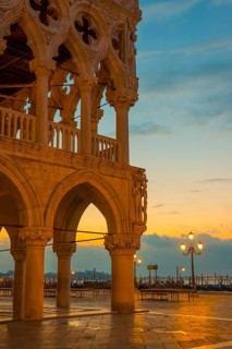 Beautiful Ducal Palace with Arches and Street Lamps and Gondola in San Marco Square in Sunset in