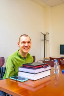 Vertical photo with concept of technology helping a man with disability to study in the university