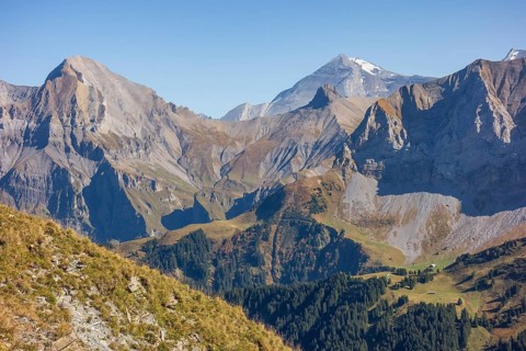 High, majestic mountains with rocky cliffs and wooded slopes, mountain panorama with rugged