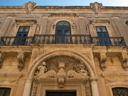 Historic building with ornate balcony and magnificent stucco ornaments, the town of mdina on the