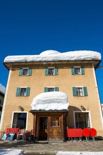 A House with Lot of Snow in a Sunny Winter Day in San Bernardino, Grisons, Switzerland, Europe