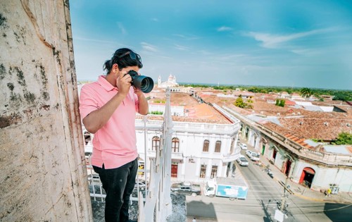 Tourist photographing the streets of Granada from the La Merced viewpoint. Tourist man taking