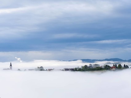 Church rises out of the morning mist, Frauenberg pilgrimage church, panoramic view, near Leibnitz,