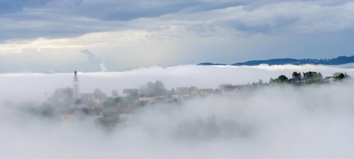 Fog clears over the village of Frauenberg, view from the Silberberg, near Leibnitz, Styria,