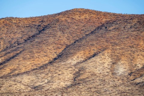 Dry red and white hills in the evening light, Epupa, Kaokoveld, Kunene, Namibia, Africa