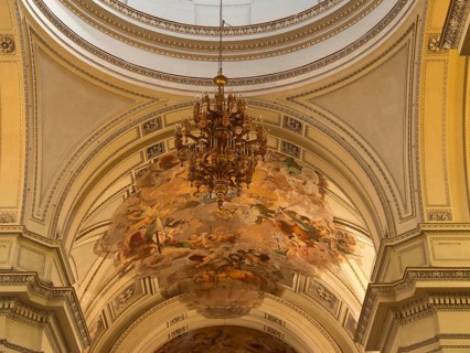 Baroque interior of a church with elaborately designed ceiling, chandelier and paintings, palermo