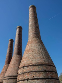 Close-up of three tall brick chimneys against a clear sky, Enkhuizen, Nirderlande