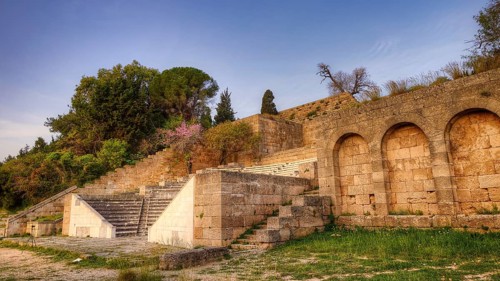 Amphitheatre, Ancient stone steps and historical ruins with vegetation and trees in the background