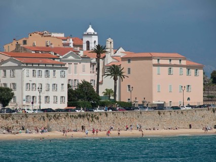 Coastal town with pastel-coloured buildings and beach area, sea view, Corsica, ajaccio, France,