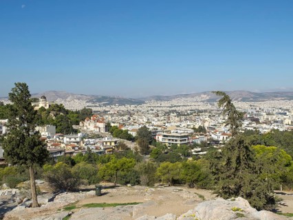 City view from a hill surrounded by buildings and trees, Ancient buildings with columns and trees