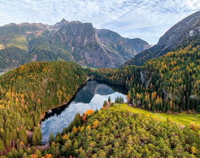 Aerial view, mountain peaks of the Oetztal Alps reflected in Lake Piburger See, in autumn, near
