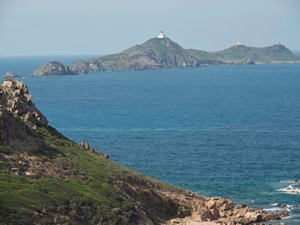 Coastal landscape with islands and lighthouses, surrounded by water and rocky cliffs, Corsica,