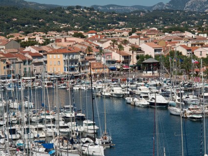 Lively marina with numerous boats and colourful houses along the coast, la seyne sur mer, france