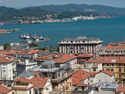City panorama with red roofs, view of harbour and hills in the distance on a sunny day, Bari,