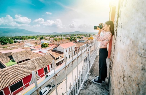 Tourist photographing the streets of Granada from the La Merced viewpoint. Tourist girl taking