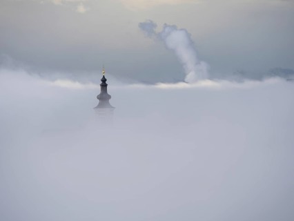 Church tower rises out of the morning mist, Frauenberg pilgrimage church, near Leibnitz, Styria,