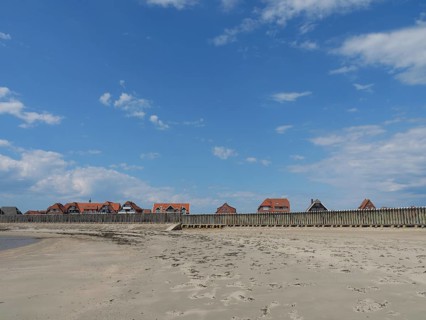 Coastal landscape with a wide beach and traditional houses, Baltrum Germany