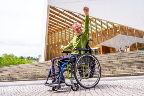 Disabled man in wheelchair proud celebrating he achieve to go to the university