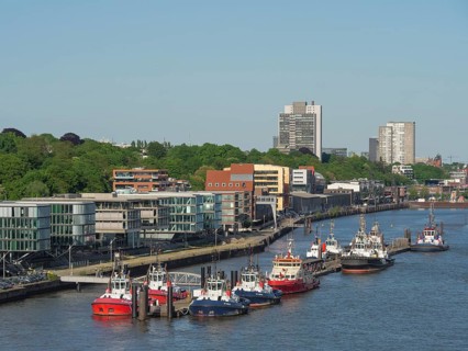 River section with modern buildings and numerous boats under a clear sky in the summer, beautiful