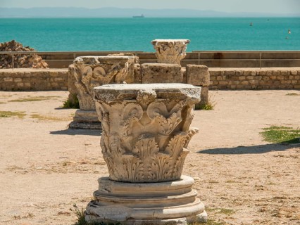 Ancient ruins overlooking the sea and historic columns on a sandy area, Tunis in Africa with ruins