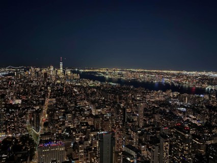 Impressive night skyline of New York with illuminated skyscrapers and a river in the background,