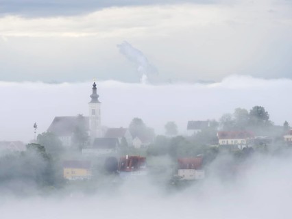 Church rises out of the morning mist, Frauenberg pilgrimage church, near Leibnitz, Styria, Austria,