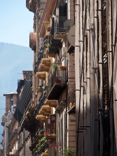 View of narrow streets with balconies and historic buildings in a mediterranean old town, palermo