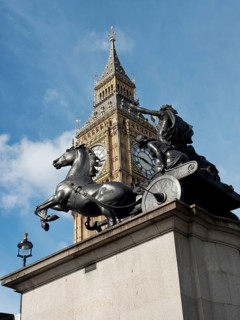 Statue of a chariot with horses in front of Big Ben in London under a cloudy sky, London, England,