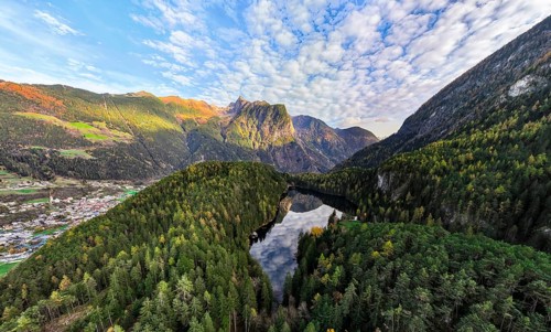 Aerial view, mountain peaks of the Oetztal Alps reflected in Lake Piburger See, in autumn, near