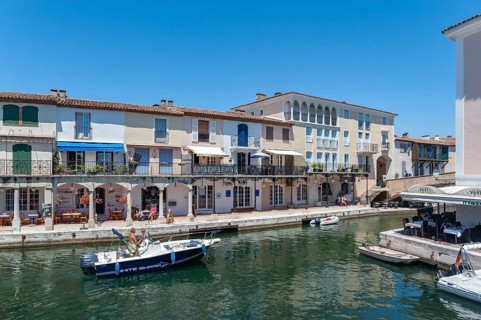 Townscape with restaurants and shops at the Pont principal du port grimaud, Port Grimaud, Var,