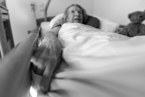 Senior citizen with dementia lying in her room in a retirement home, portrait, Baden-Wuerttemberg,
