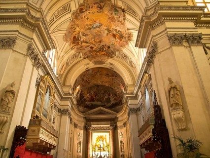 Magnificent church interior with ornate ceiling frescoes and decorative elements in a warm