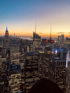 Modern cityscape at sunset with glowing skyscrapers and an atmospheric sky, the skyline of new york