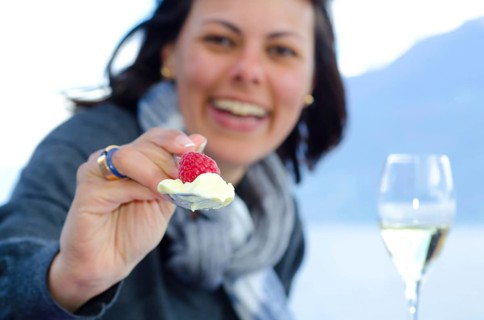 Happy Woman Giving Raspberry Fruit and Ice Cream with a Spoon in Switzerland