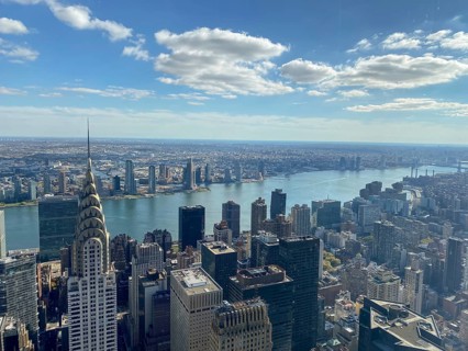 Daytime view of a large city with a view of the river and numerous skyscrapers, including the