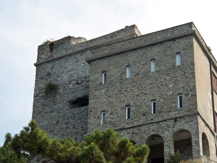 Old, historic building with stone walls and castle tower, surrounded by vegetation, Bari, Italy,