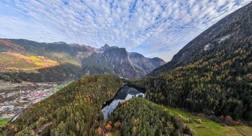 Aerial view, mountain peaks of the Oetztal Alps reflected in Lake Piburger See, in autumn, near