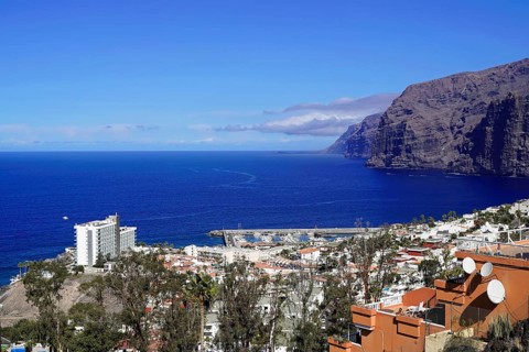 Steep coast of Los Gigantes, Canary Islands, Spain, Europe, coastal town with harbour and white