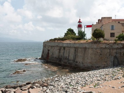 Coastline with a lighthouse and old buildings on a rocky coast, Corsica, ajaccio, France, Europe