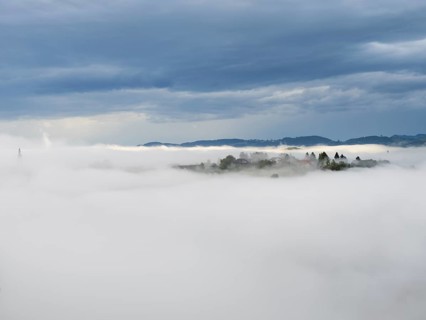 Morning fog over the village of Frauenberg, view from Silberberg, near Leibnitz, Styria, Austria,