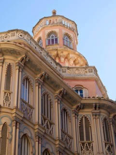 Pink building with decorative elements and a tower with shutters, palma de Majorca with its