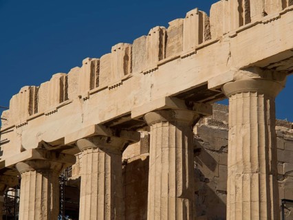 Side view of an ancient temple with columns in bright light and clear sky, Ancient buildings with